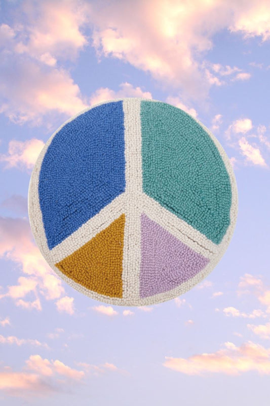 Round pillow in the shape of a peace sign with colors in each separation 